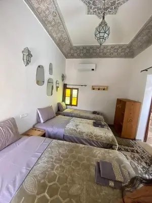 a bedroom with two beds and a ceiling at Dar ZaZ in Fès
