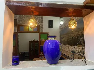 a large blue vase sitting on a table with lights at Dar ZaZ in Fès
