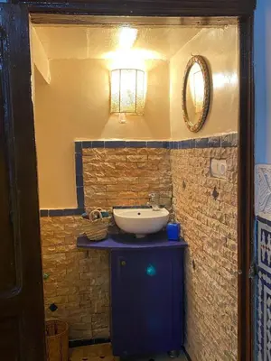 a bathroom with a sink and a mirror at Dar ZaZ in Fès