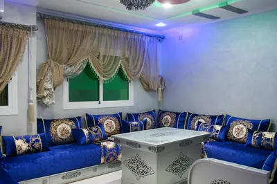 a living room with a blue couch and a table at city fes in Fès