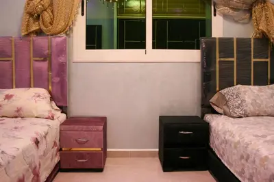 a bedroom with two beds and a window at city fes in Fès