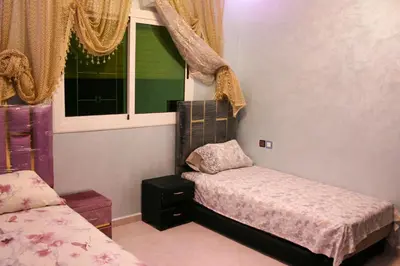 a small bedroom with a bed and a window at city fes in Fès