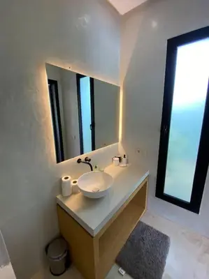 a white bathroom with a sink and a mirror at Villa P5 avec piscine chauffée in Marrakech