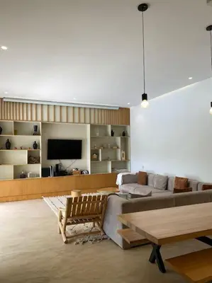 a living room with a couch and a table at Villa P5 avec piscine chauffée in Marrakech