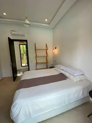 a bedroom with a large bed and a window at Villa P5 avec piscine chauffée in Marrakech
