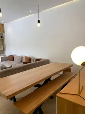 a living room with a table and a couch at Villa P5 avec piscine chauffée in Marrakech