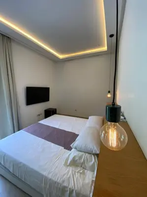 a bedroom with a bed and a table with a lamp at Villa P5 avec piscine chauffée in Marrakech