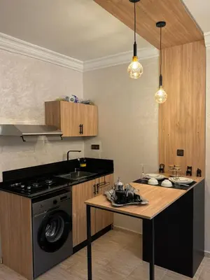 a kitchen with a stove and a counter top at Atlas appartement in Fès