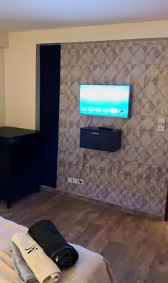 a flat screen tv on a wall in a bedroom at Atlas appartement in Fès