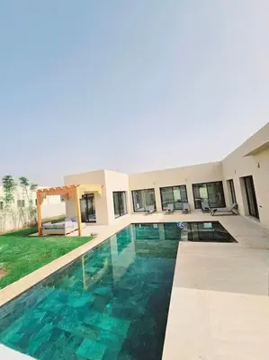 a house with a swimming pool in front of it at Villa Piscine Sans Vis à Vis in Marrakech