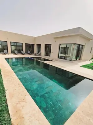 a swimming pool in front of a house at Villa Piscine Sans Vis à Vis in Marrakech