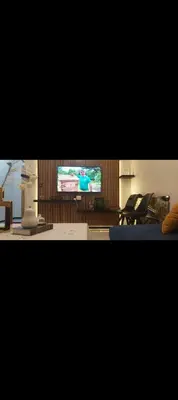 a living room with a flat screen tv and a couch at Mamoune benz in Fès