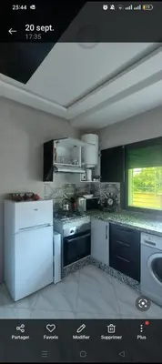 a kitchen with white appliances and a window at Mamoune benz in Fès
