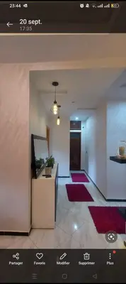 a view of a living room with red rugs at Mamoune benz in Fès