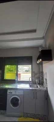 a kitchen with a sink and a washing machine at Mamoune benz in Fès