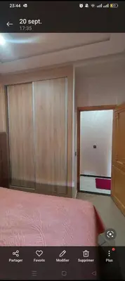 a bedroom with a bed and a sliding glass door at Mamoune benz in Fès