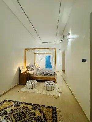 a bedroom with a bed with two pillows at Riad Kasbah Ben Hamo in Nkob