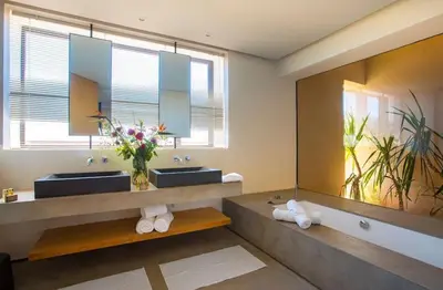a bathroom with two sinks and a large mirror at Palais des jardins in Ouarzazate