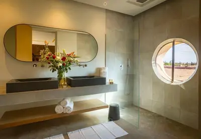 a bathroom with a sink and a mirror at Palais des jardins in Ouarzazate