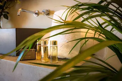 two glass bottles sitting on a counter in a bathroom at Palais des jardins in Ouarzazate