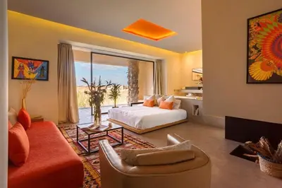 a living room with a bed and a couch at Palais des jardins in Ouarzazate
