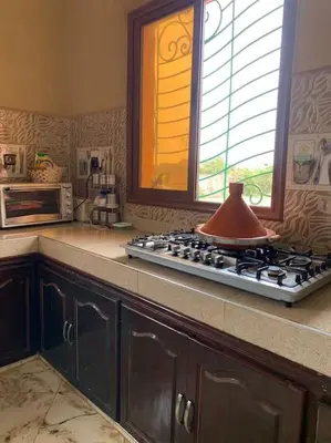 a kitchen with a stove with a tea kettle on it at Séjour Authentique à Marrakech in Marrakech