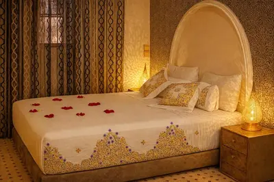 a bedroom with a bed with an arched headboard at Riad Rayhana Fes-Luxury Stay Fes Medina in Fès