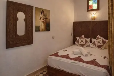 a bedroom with a bed and a picture of a woman at Riad Rayhana Fes-Luxury Stay Fes Medina in Fès