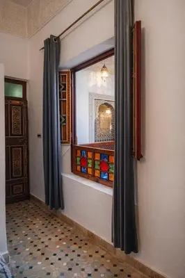 a window in a room with a curtain at Riad Rayhana Fes-Luxury Stay Fes Medina in Fès