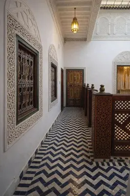 a hallway with a door and a checkered floor at Riad Rayhana Fes-Luxury Stay Fes Medina in Fès