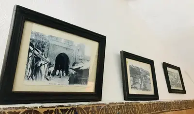 three framed pictures on a shelf on a wall at Riad Zahraa Al Ismailia in Meknès