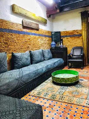 a living room with a couch and a table at Riad Zahraa Al Ismailia in Meknès