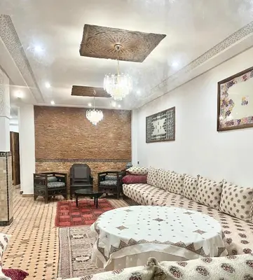 a living room with a couch and a table at Riad Zahraa Al Ismailia in Meknès