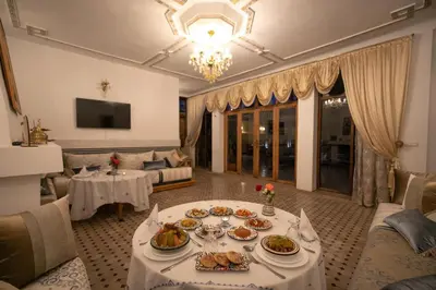 a living room with a table with food on it at Riad Louna Fes & Spa in Fès