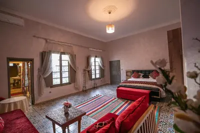 a large room with two beds and a couch at Riad Louna Fes & Spa in Fès