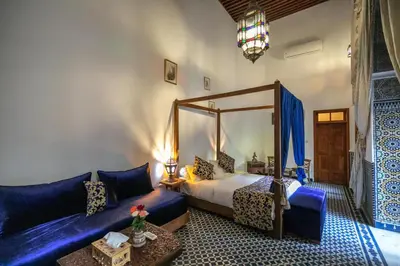 a bedroom with a bed and a couch at Riad Louna Fes & Spa in Fès
