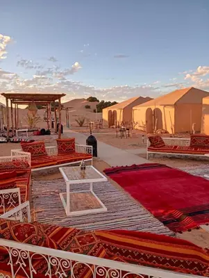 a group of tents in the middle of the desert at Merzouga Desert Activities & Events in Merzouga