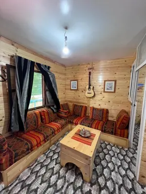 a living room with a couch and a table at Tikida house in Ouzoud