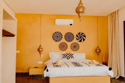a bedroom with a bed with plates on the wall at Villa de luxe in Marrakech