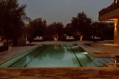 a swimming pool in a yard at night at Villa de luxe in Marrakech