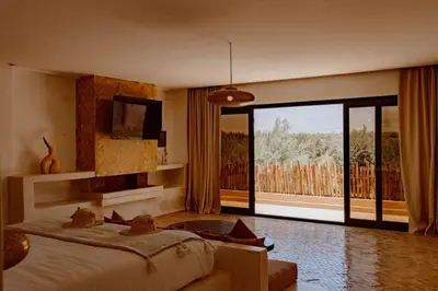 a bedroom with a bed and a large window at Villa de luxe in Marrakech