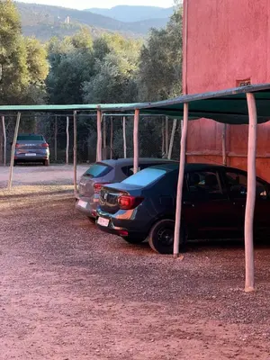 two cars are parked under a building at Tikida house in Ouzoud