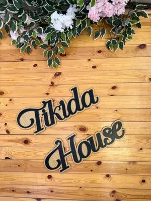a sign that says chia flower on a wooden table at Tikida house in Ouzoud