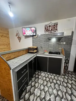 a kitchen with a sink and a tv on a wall at Tikida house in Ouzoud