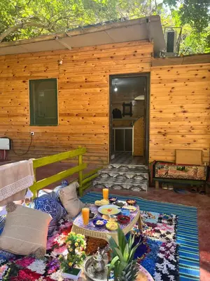 a living room with a table and a patio at Tikida house in Ouzoud