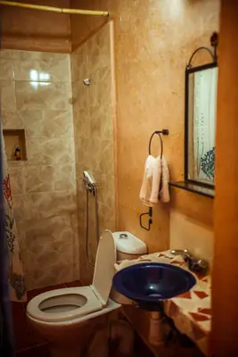 a bathroom with a toilet and a sink at Riad Zaytoune in Ouarzazate