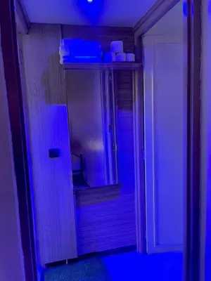 a bathroom with a mirror and a blue light at hotel darna with air conditioning in Er Rachidia
