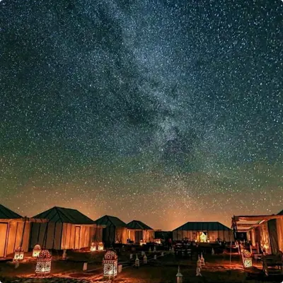 a starry night with a milky way in the sky at Merzouga Dunes Luxury Glamping Camp in Merzouga
