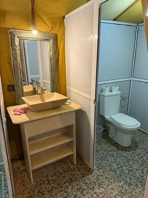 a bathroom with a sink and a toilet at Merzouga Dunes Luxury Glamping Camp in Merzouga