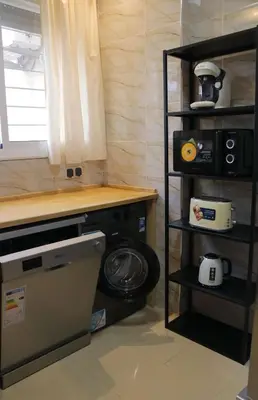 a laundry room with a washing machine and a window at Jolie appartement à Ifrane calme et spacieux in Ifrane